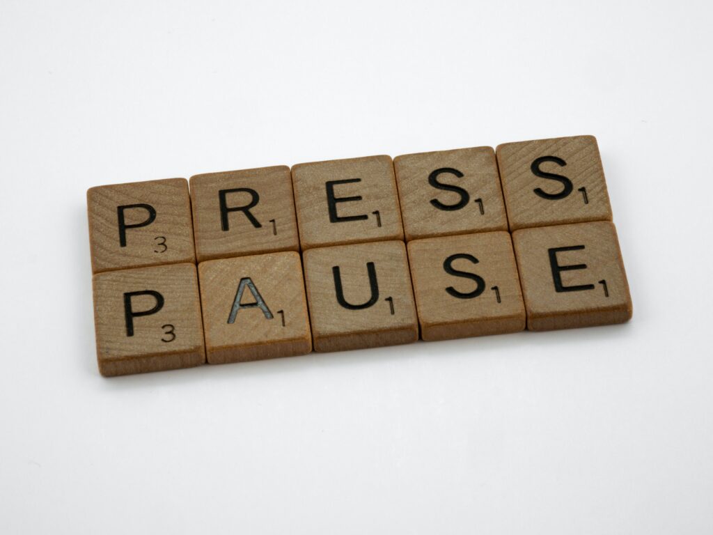 Scrabble tiles saying 'Press Pause'