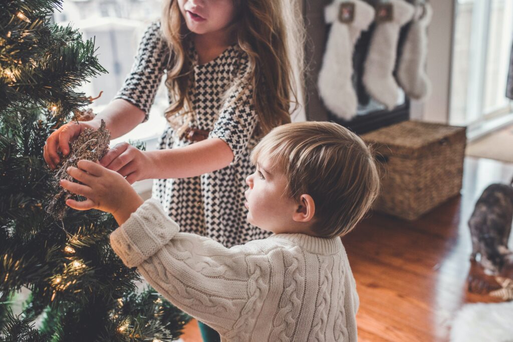 children dressing Christmas tree