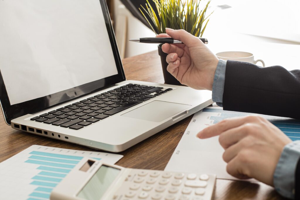 Businessman with laptop and calculator at the office