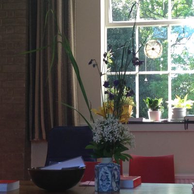 2015 05 17 Choisya in MfW a vase of flowers on a table with folders